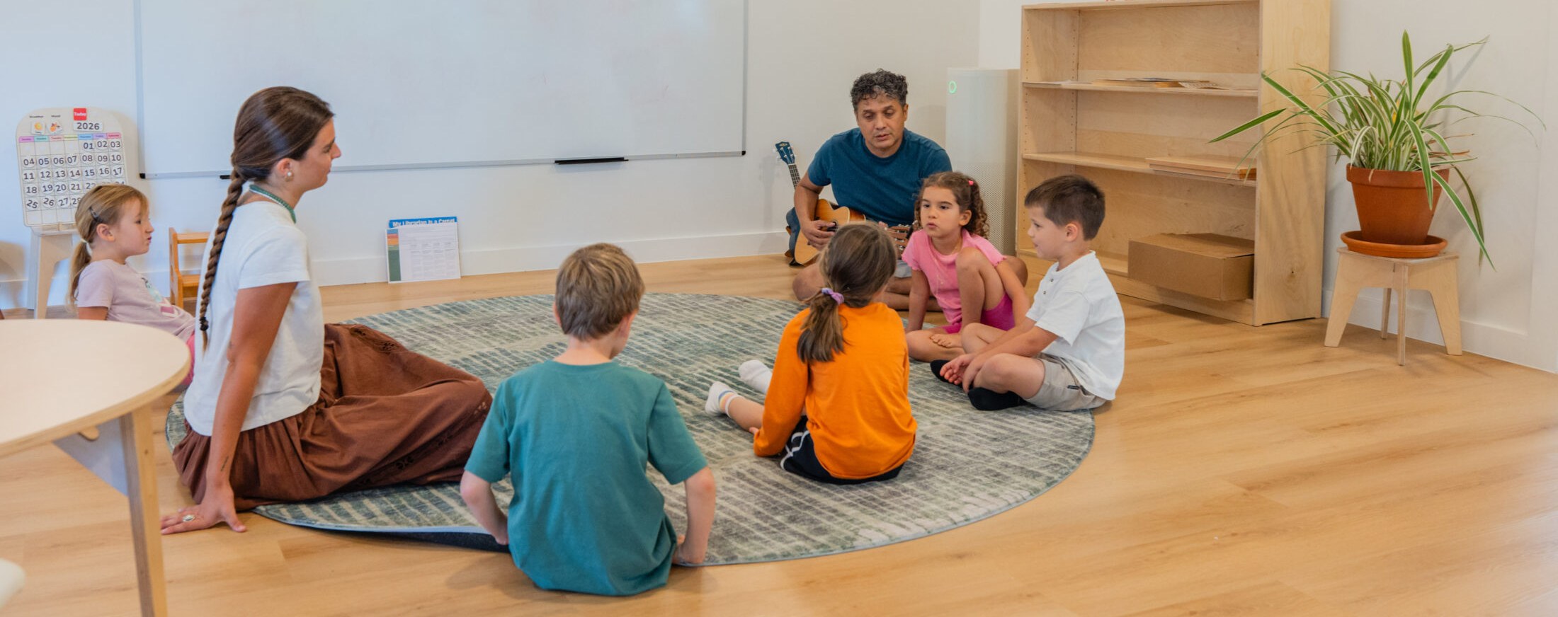 Kindling Academy teachers and children sitting in a circle
