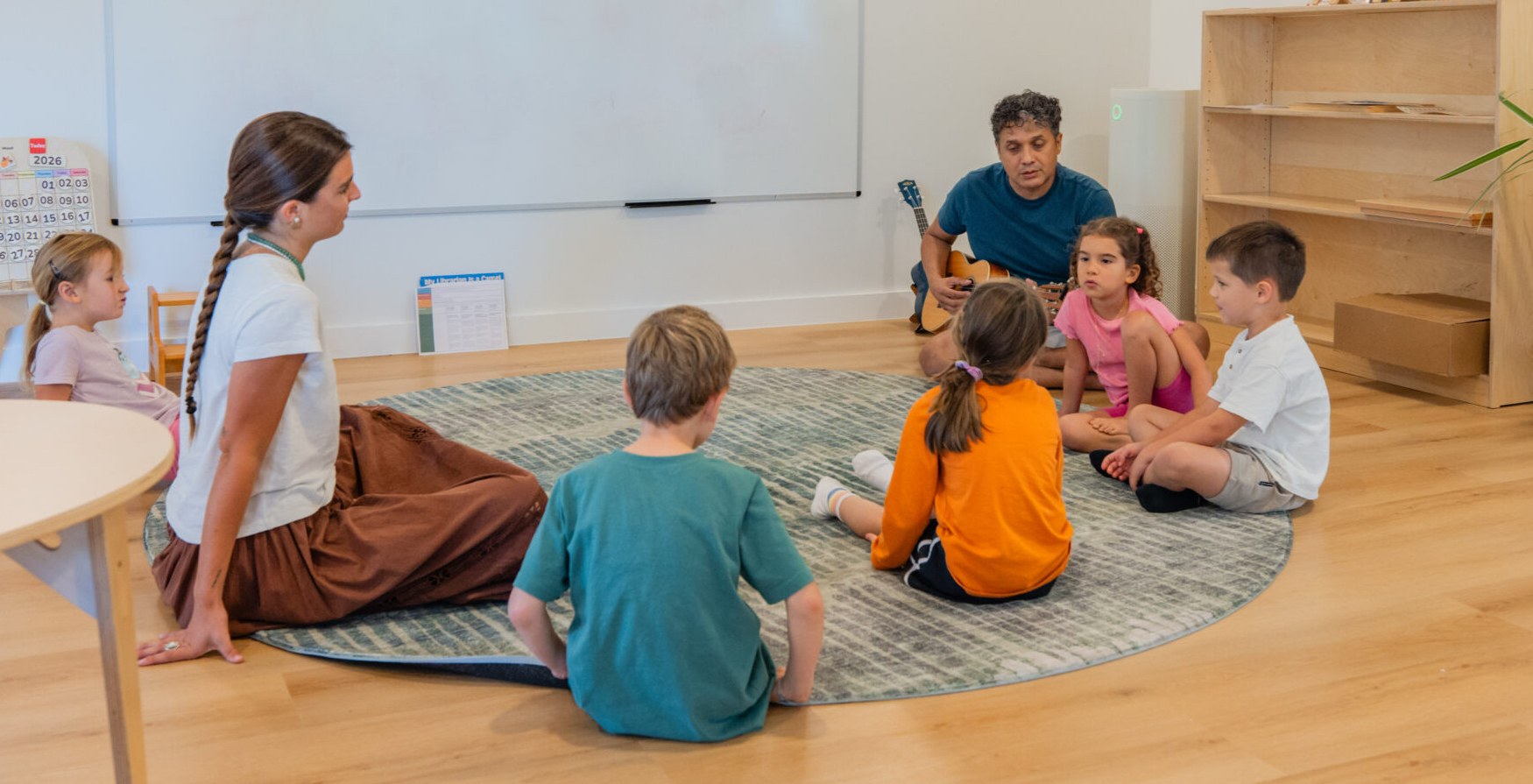 Kindling Academy teachers and children sitting in a circle